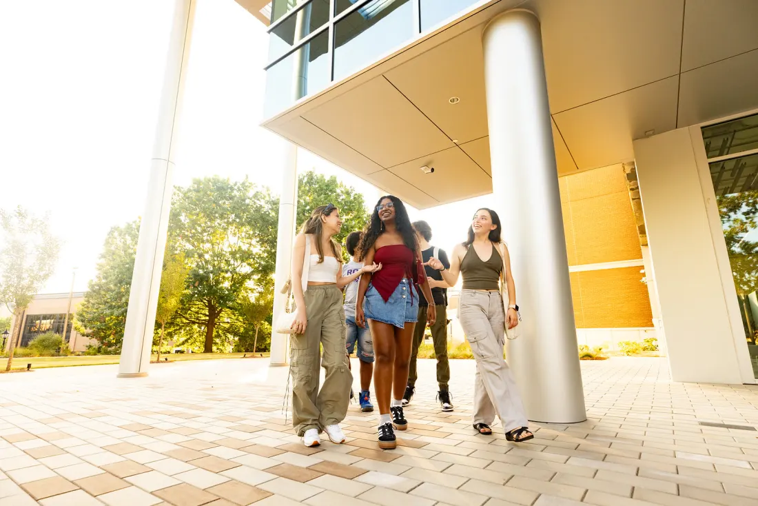 Sabrina and Mavi walking on campus